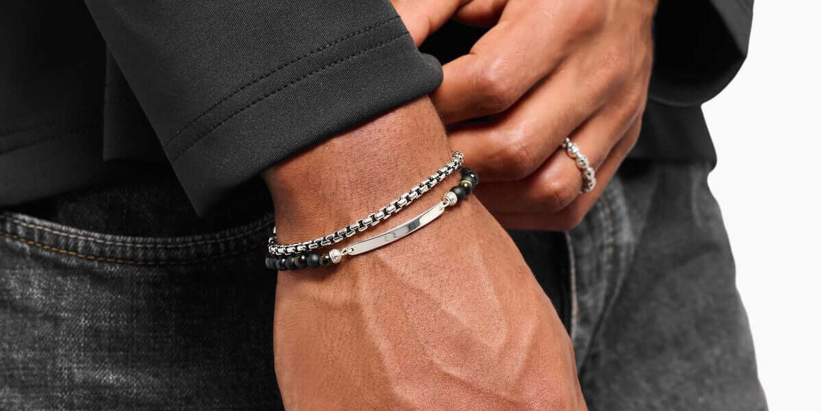 luxury men's leather bracelets showcased on a wrist, featuring details like silver chain and natural stones.