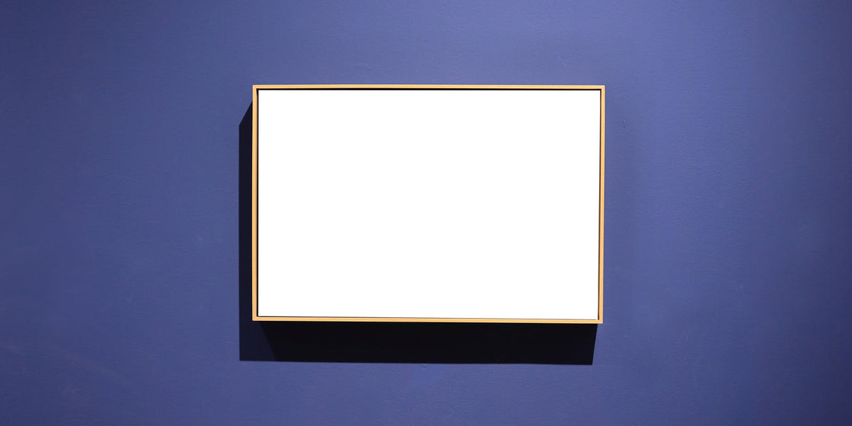White frame on a blue wall showcasing unique art pieces for home decor.