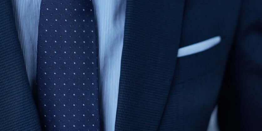 Elegant men's jackets featuring a tailored suit with a striped shirt and polka dot tie.