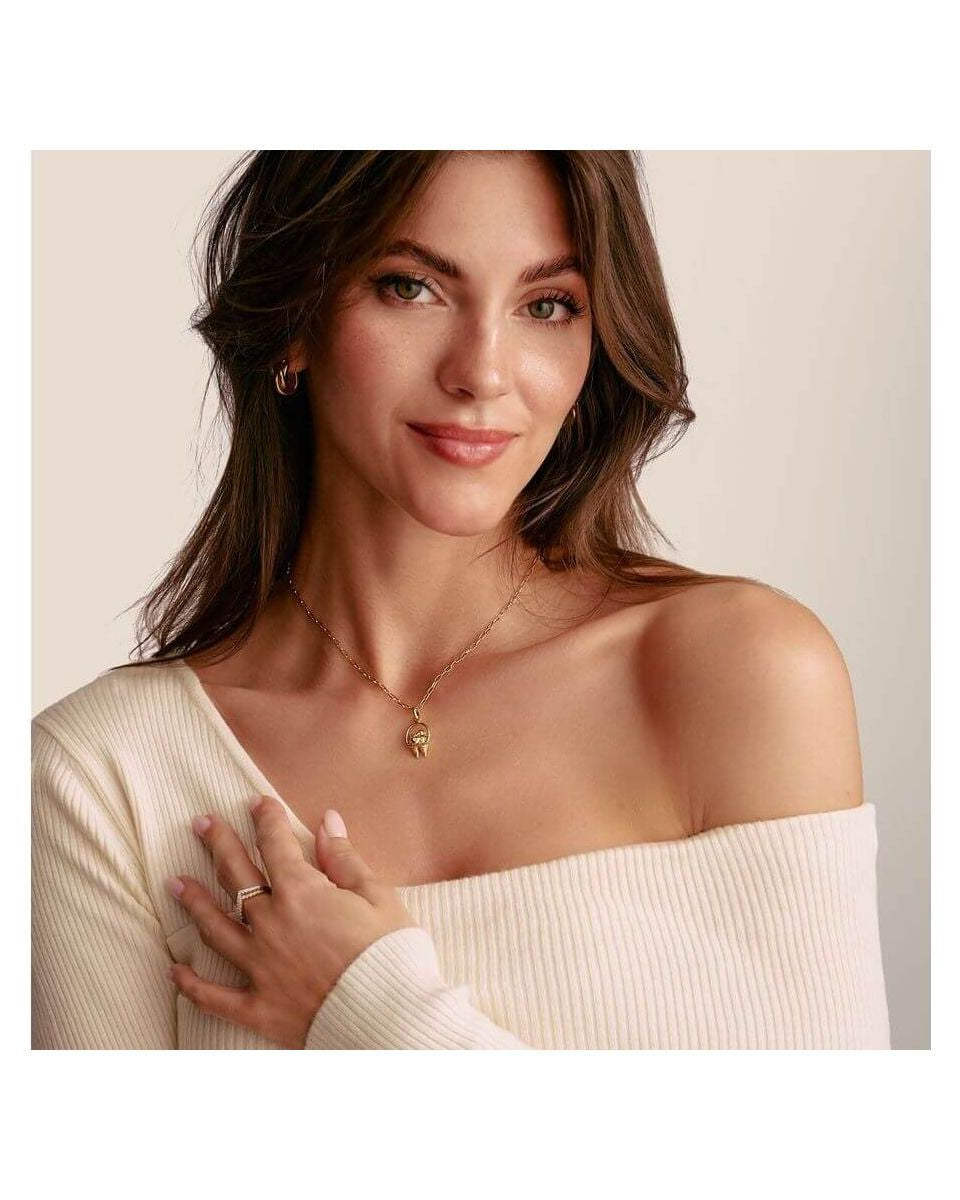 Woman wearing a charm pendant necklace featuring delicate birds and a heart, showcasing elegance and style.