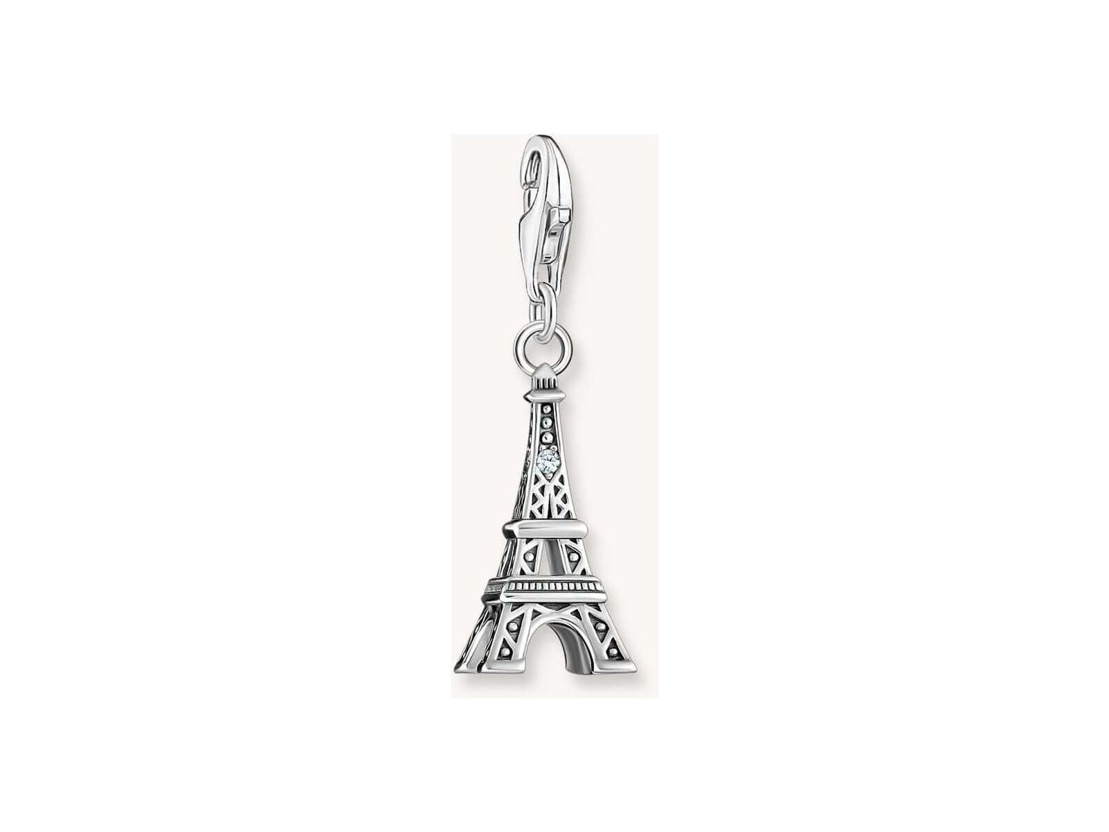Charm pendant of the Eiffel Tower in recycled silver with a white zirconia, capturing vintage elegance.