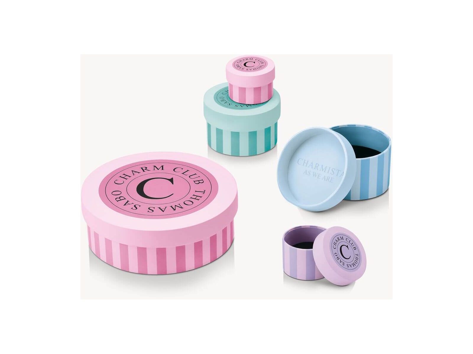 Colorful charming gift boxes with pink and blue designs for Charm Club by Thomas Sabo.
