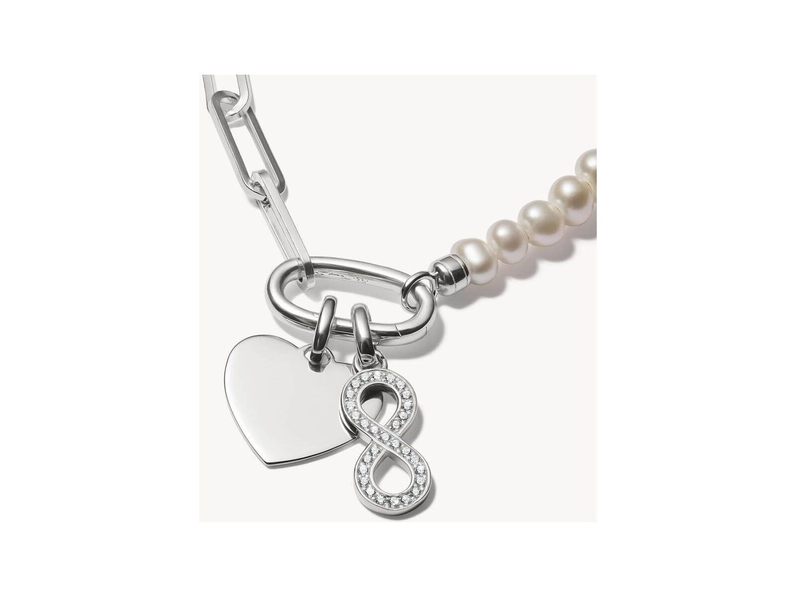 Pendentif argent 925 recyclé avec symbole infini et pierres en zirconium, élégant sur chaîne ou bracelet.