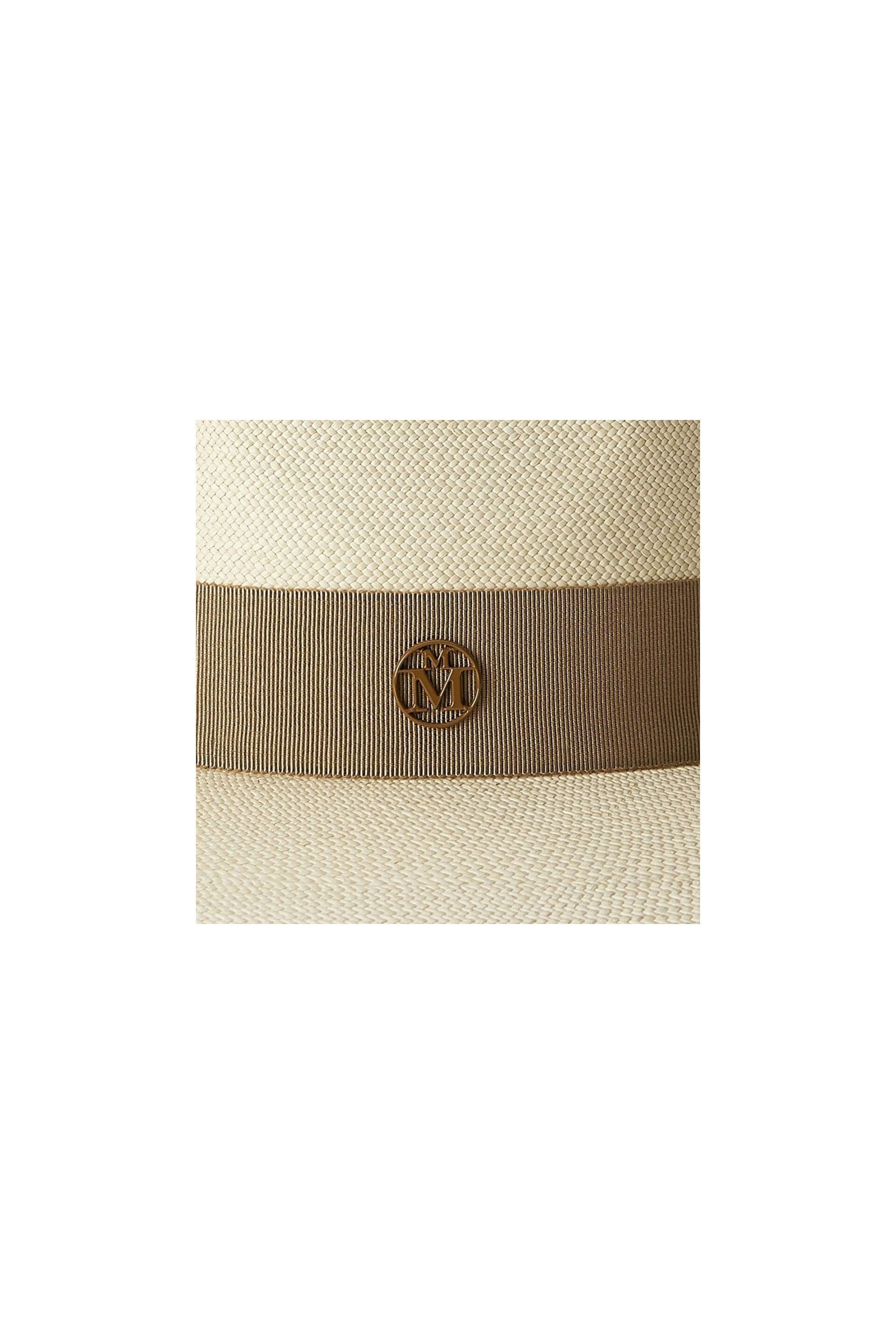 Close-up of the Chapeau Charles timeless Cuenca hat featuring a stylish ribbon and emblem detail.