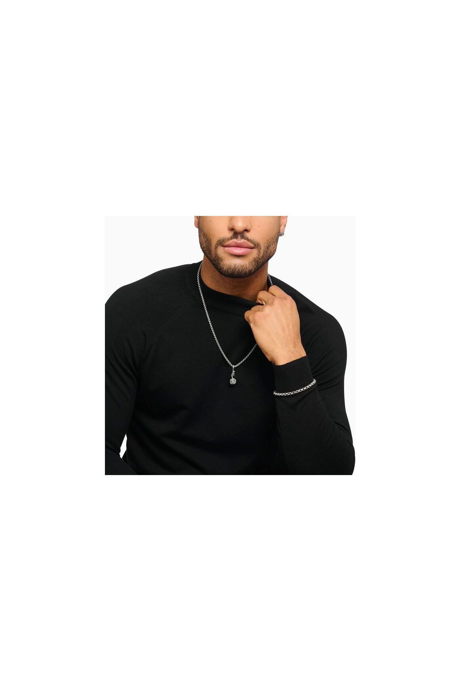 Man wearing a silver Midnight Rose pendant necklace and bracelet, showcasing stylish jewelry design.