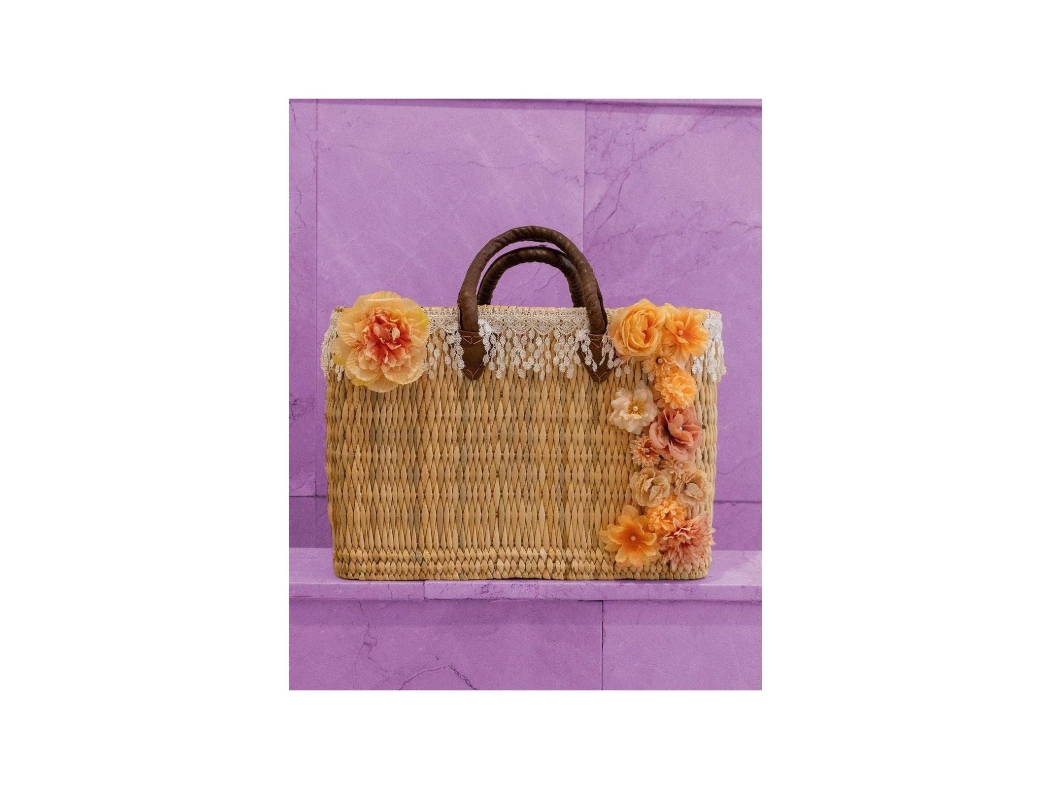 Panier en osier décoré de fleurs colorées, idéal pour un look tendance et naturel, parfait pour les sorties estivales.