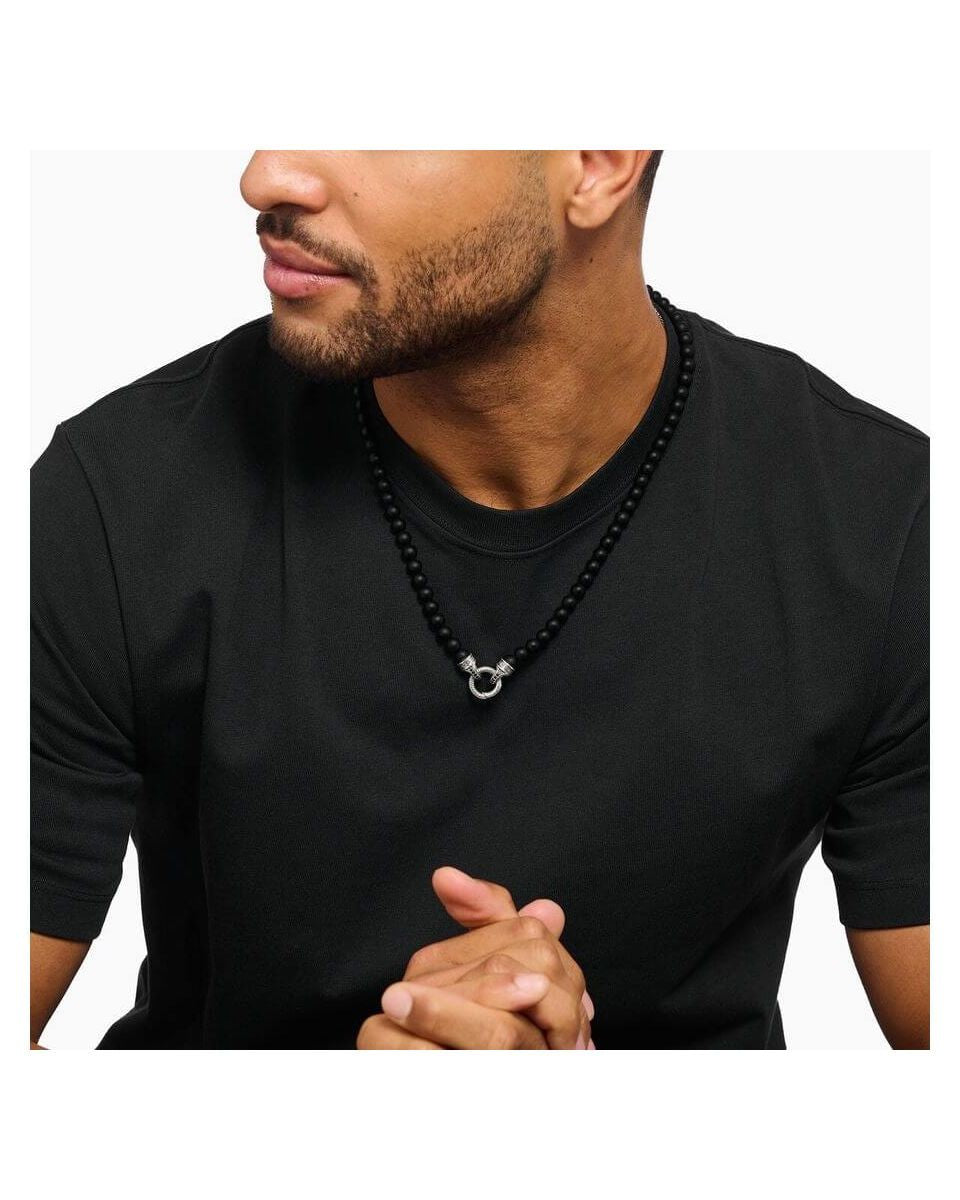 Man wearing a 60 cm black obsidian beads necklace with a decorative silver clasp.