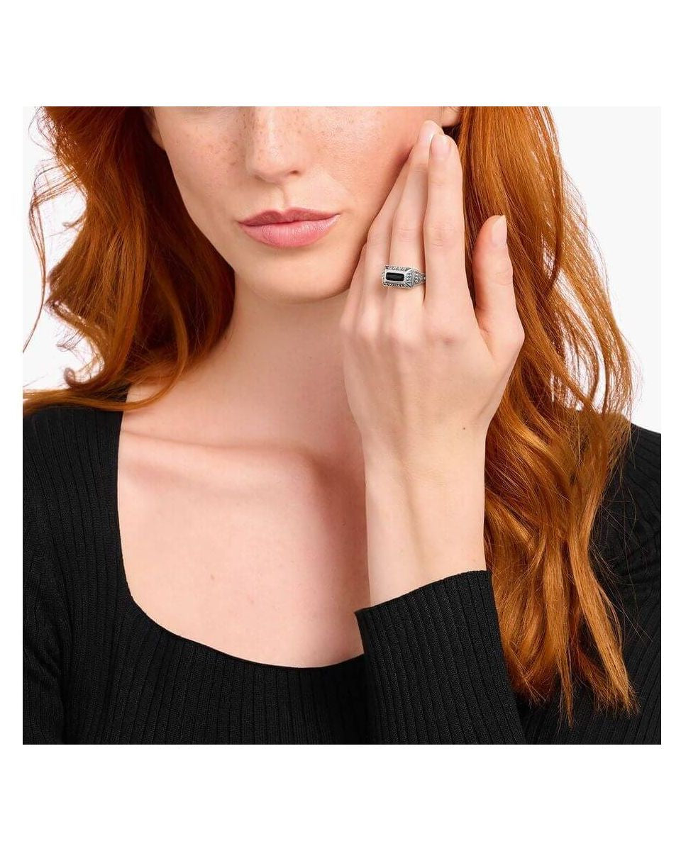 Elegantly showcasing the Bague collège ring, a silver craftsmanship piece with a stunning design and personal talisman.