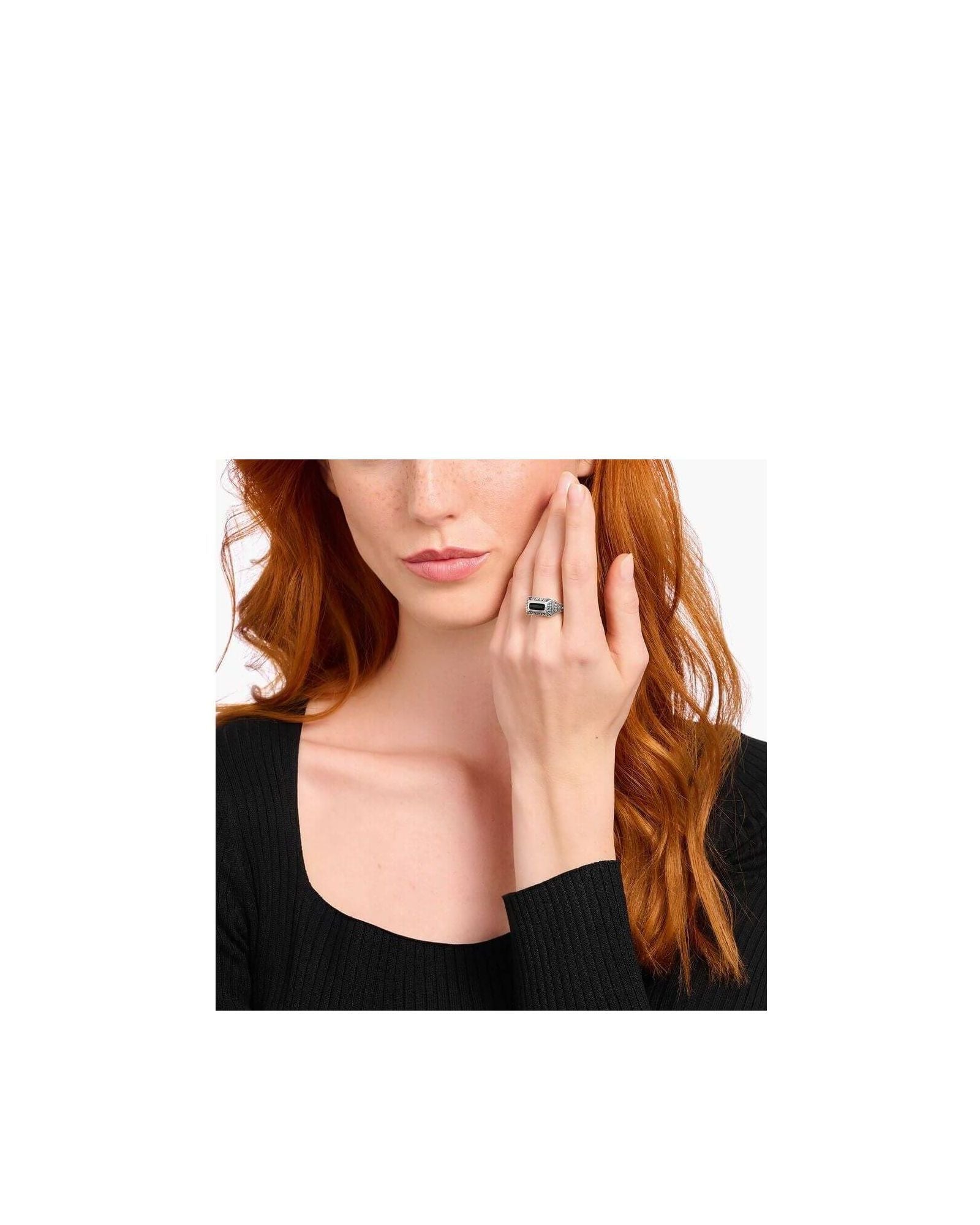 Elegantly showcasing the Bague collège ring, a silver craftsmanship piece with a stunning design and personal talisman.