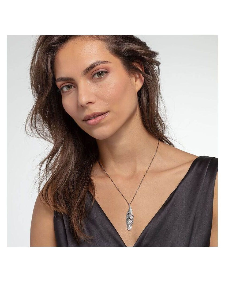 Femme portant le pendentif plume en argent sterling noirci de THOMAS SABO, mettant en avant son élégance.