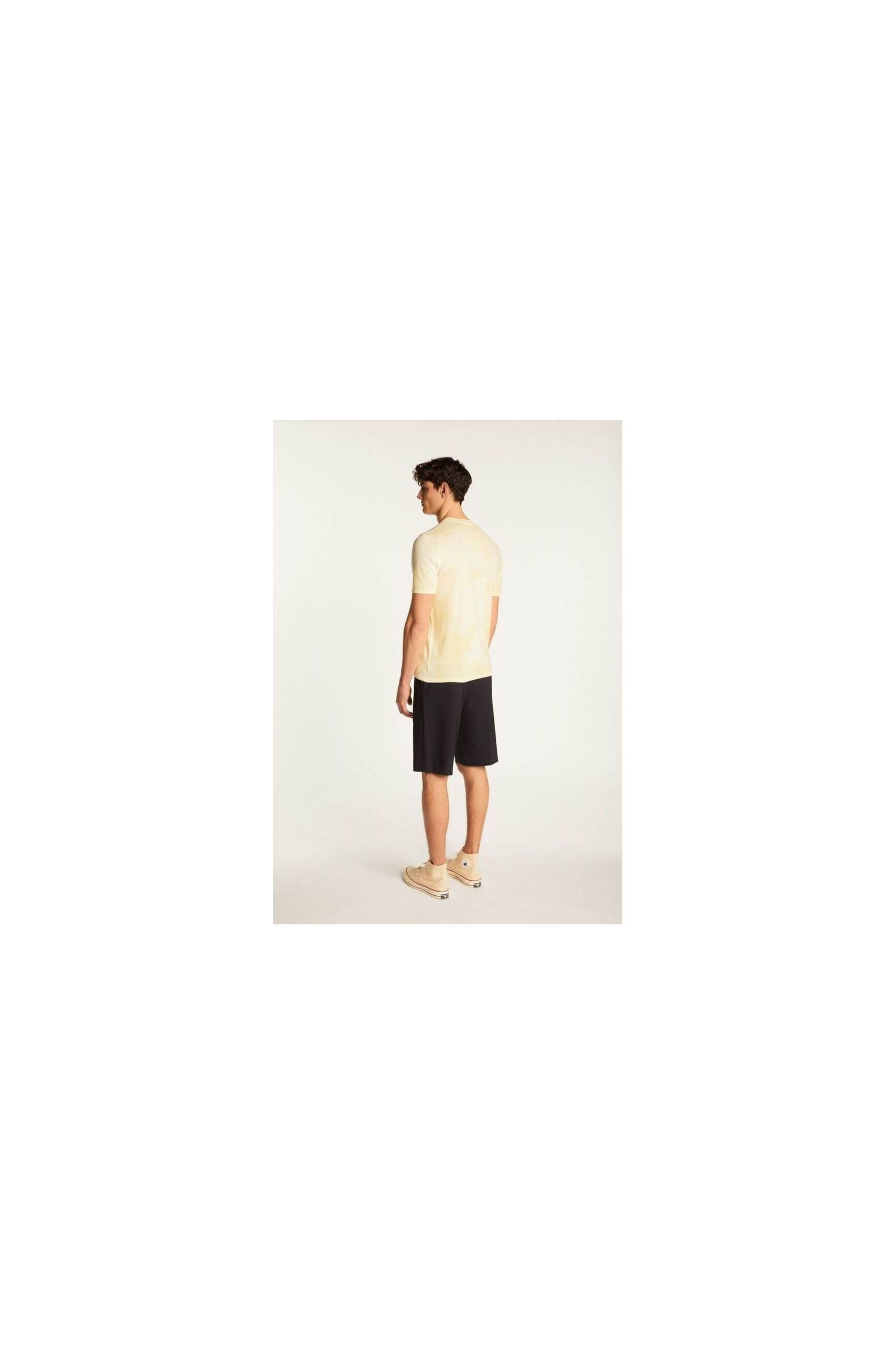Back view of a model wearing the T-Shirt Marquez in light yellow with shorts, showcasing its modern style.