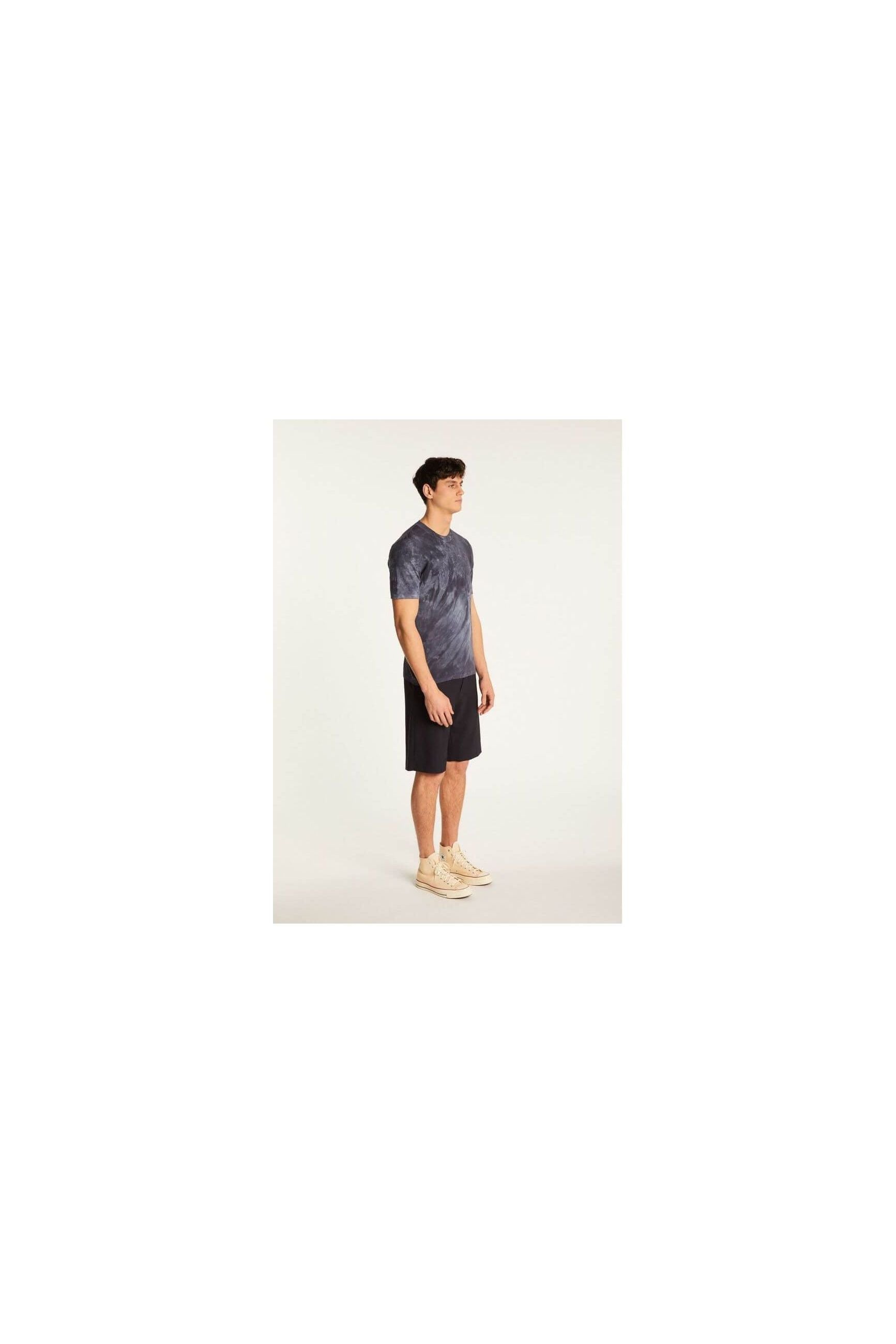 Model displaying the Marquez T-Shirt in a stylish tie-dye pattern, paired with shorts for a casual look.