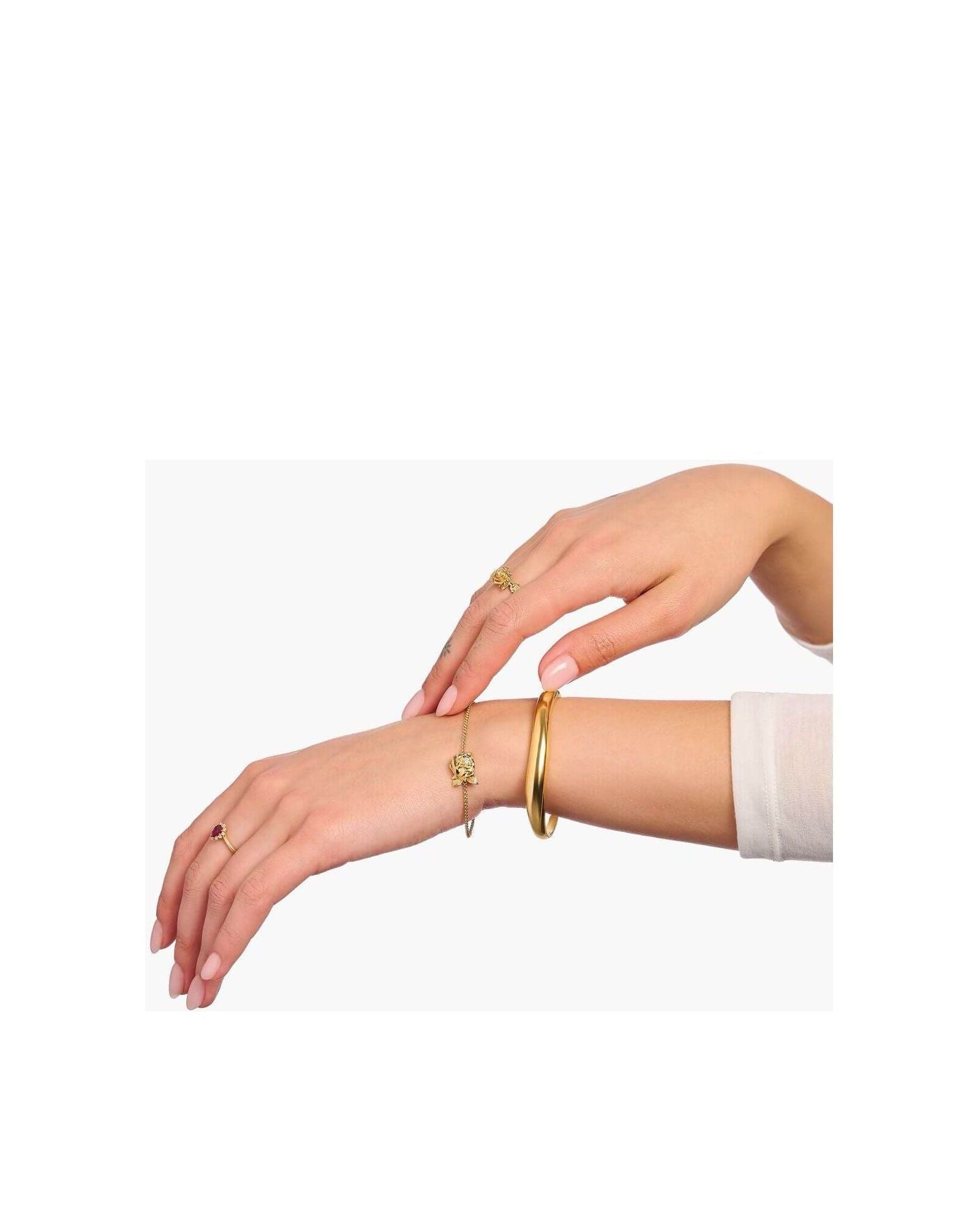Mainly gold jewelry including rings and bracelets worn on elegant hands for a sophisticated look.