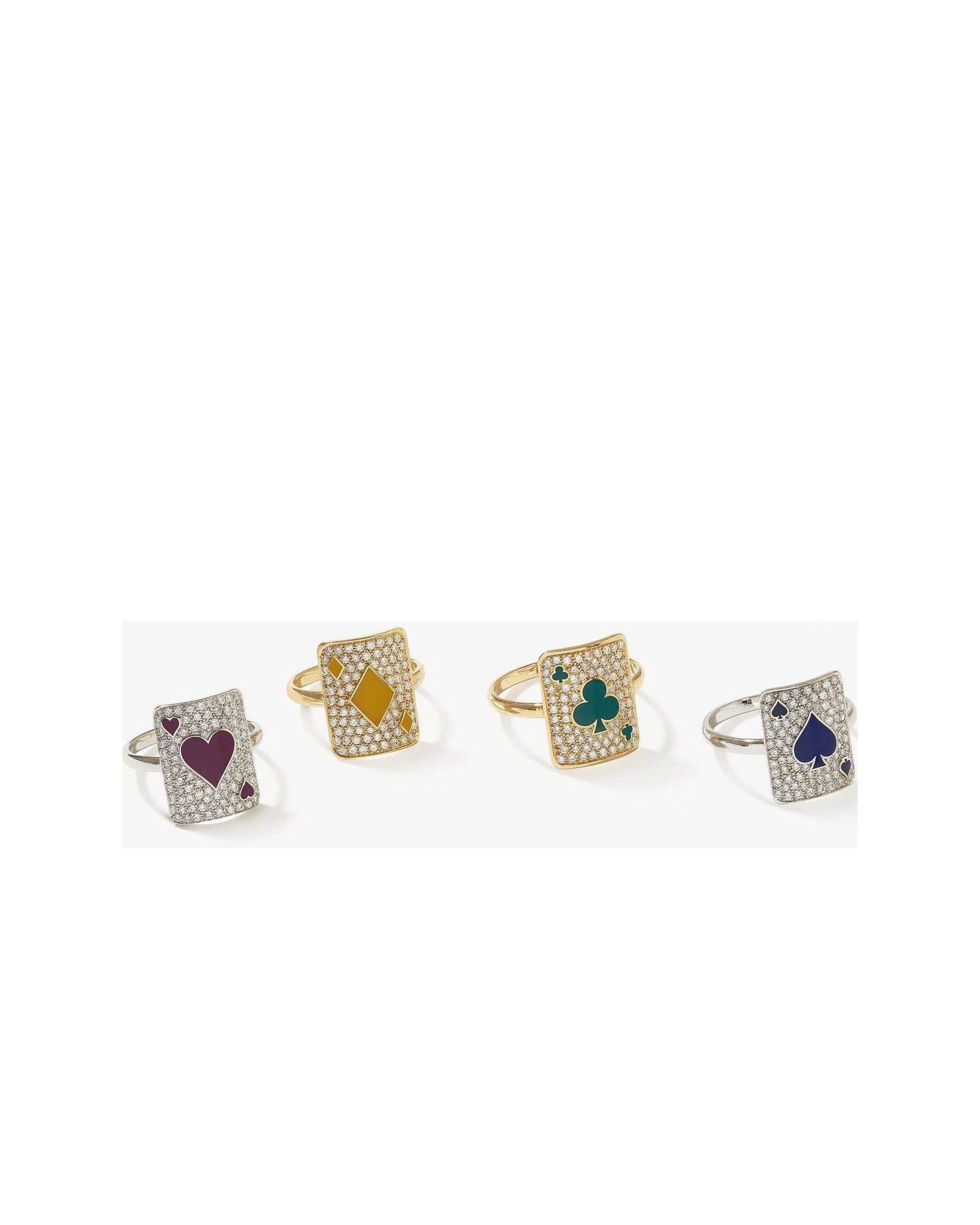 Set of four sparkling rings each featuring playing card designs with hearts, diamonds, clubs, and spades.