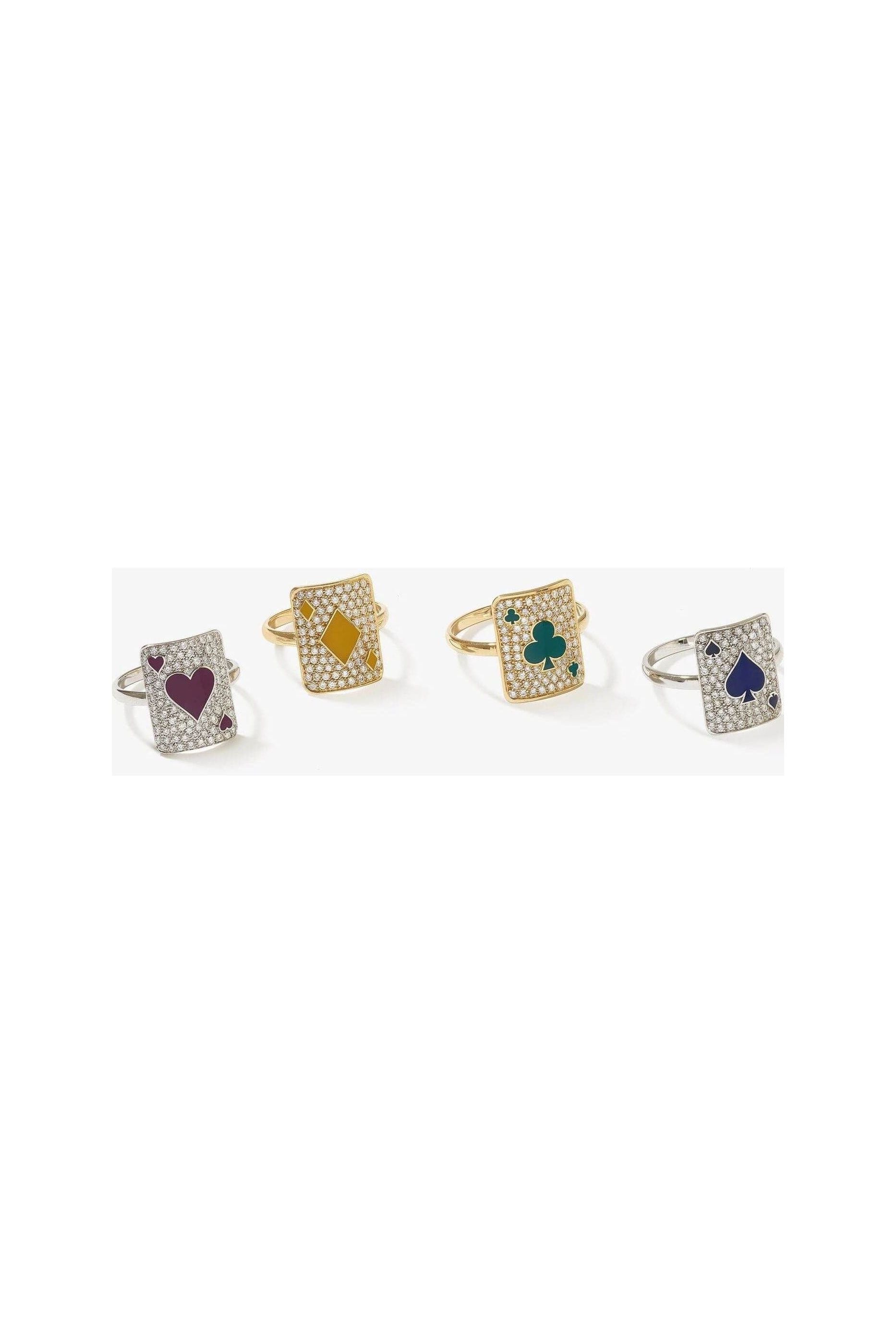 Set of four sparkling rings each featuring playing card designs with hearts, diamonds, clubs, and spades.