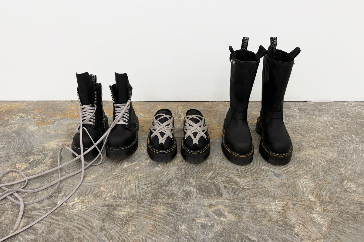 Image of Rick Owens Dr. Martens collaboration featuring stylish boots and shoes on a textured surface.