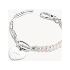 Pendentif charm en argent en forme de cœur avec perles, gravé 'yours', sur bracelet élégant.