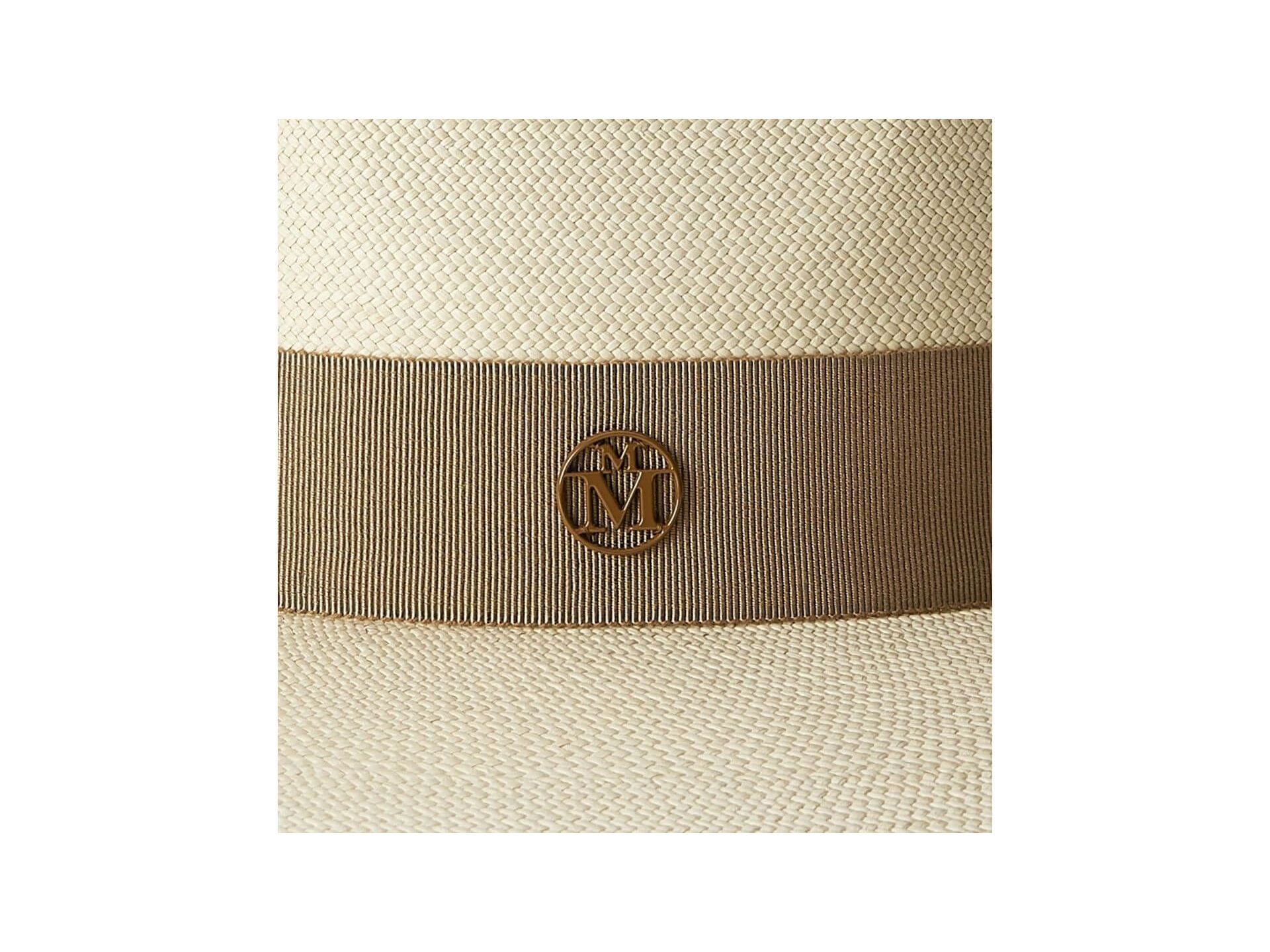 Close-up of the Chapeau Charles timeless Cuenca hat featuring a stylish ribbon and emblem detail.