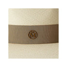 Close-up of the Chapeau Charles timeless Cuenca hat featuring a stylish ribbon and emblem detail.
