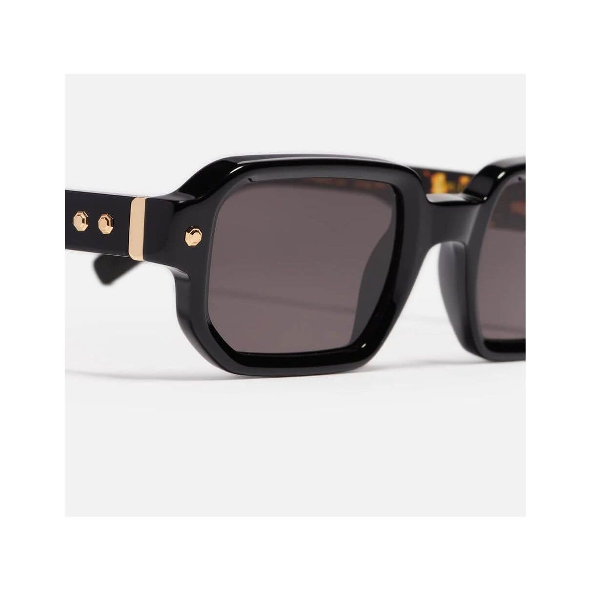 Shiny black rectangular sunglasses with gold accents from Project 06, unisex design.