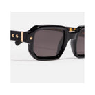 Shiny black rectangular sunglasses with gold accents from Project 06, unisex design.
