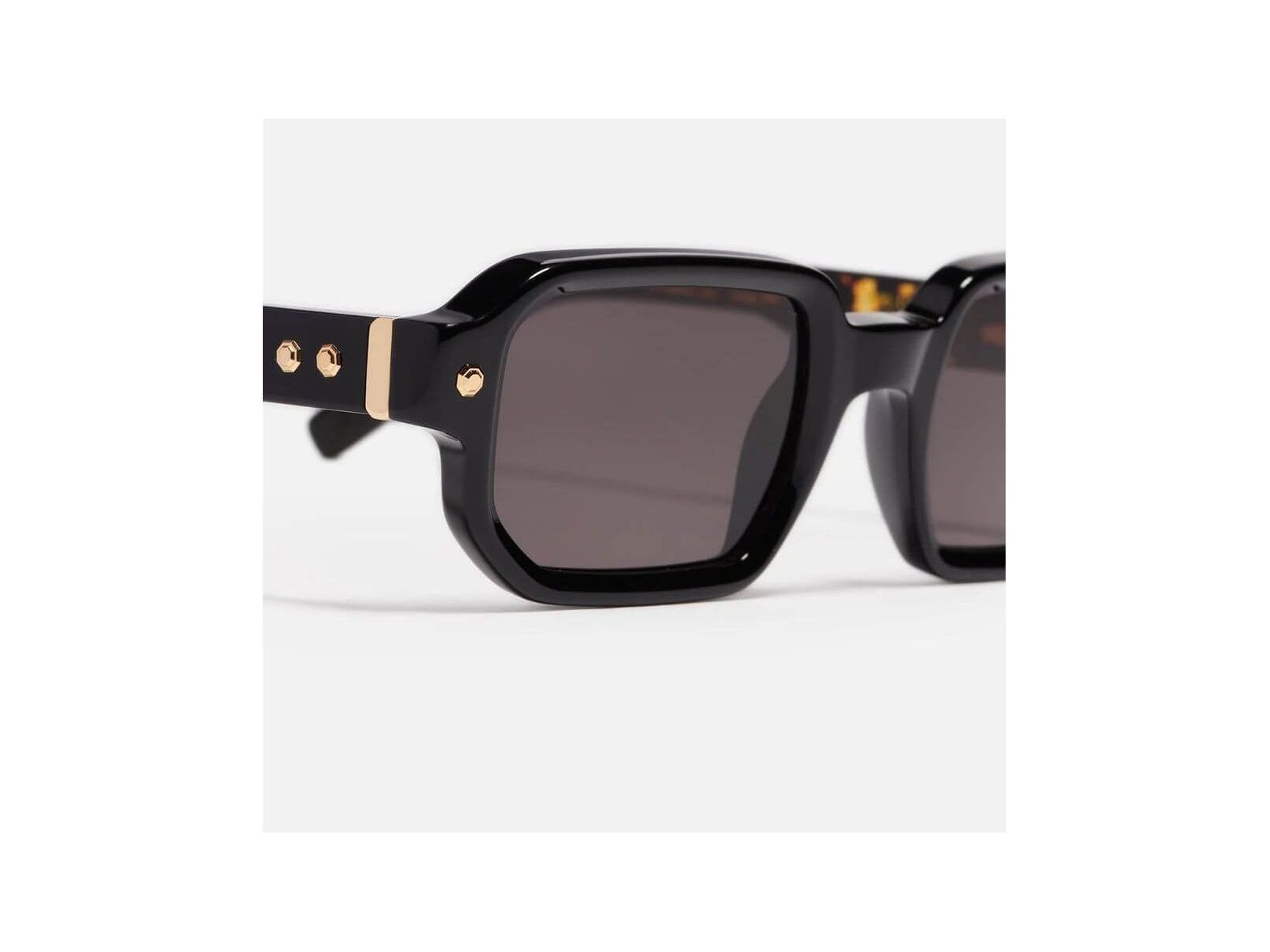 Shiny black rectangular sunglasses with gold accents from Project 06, unisex design.