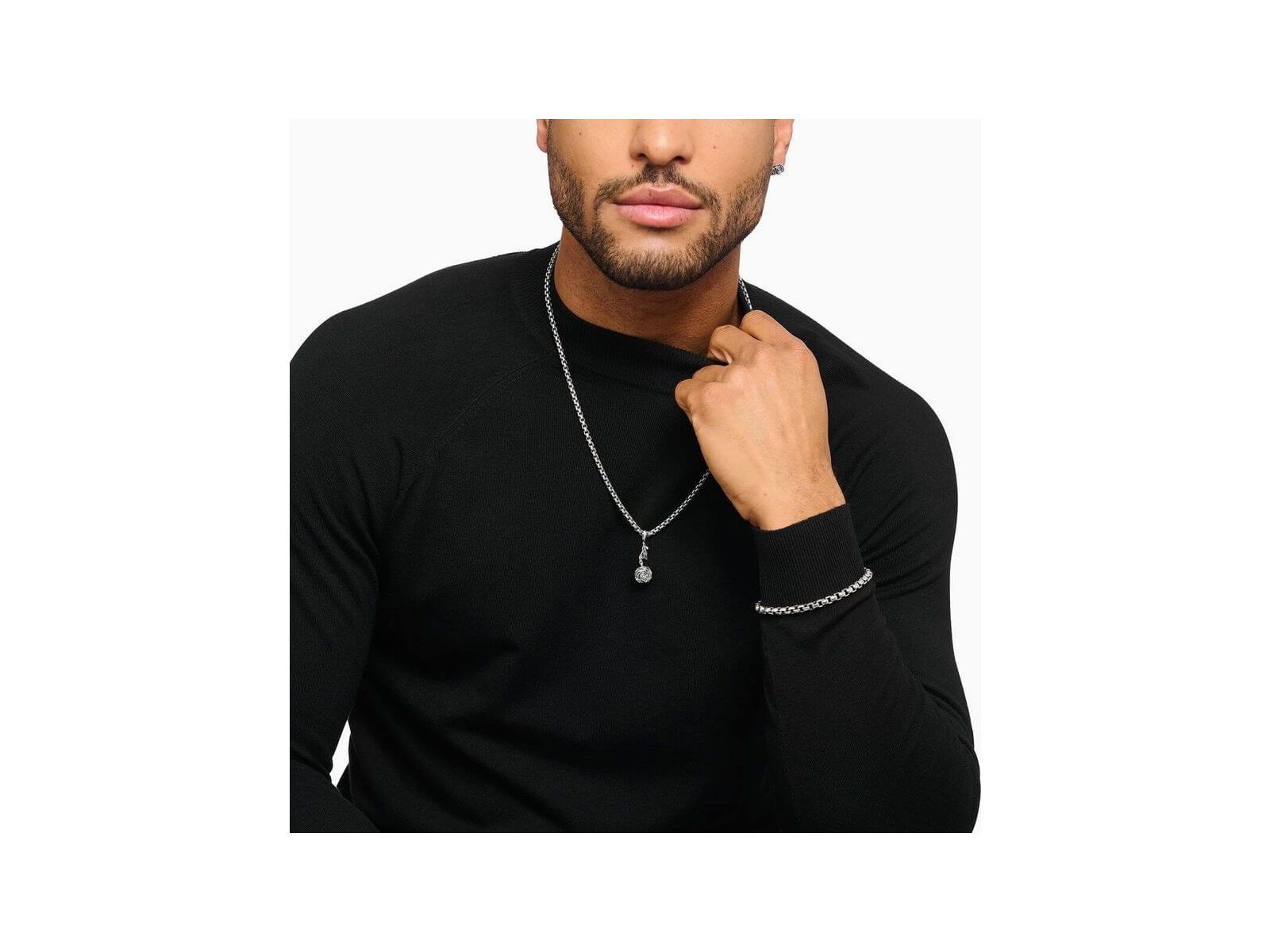 Man wearing a silver Midnight Rose pendant necklace and bracelet, showcasing stylish jewelry design.