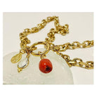 Collier Madone bracelet featuring Mediterranean red coral and gold links, showcasing elegance and craftsmanship.