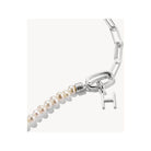 Close-up of a silver charm pendant with a letter 'H' and pearls, perfect for personalized jewelry.
