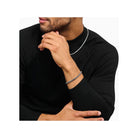 Homme portant un bracelet en argent box chain, avec un design élégant, associé à un t-shirt noir.