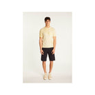 Model wearing a lightweight, breathable yellow T-Shirt Marquez with a discreet pocket, paired with dark shorts.