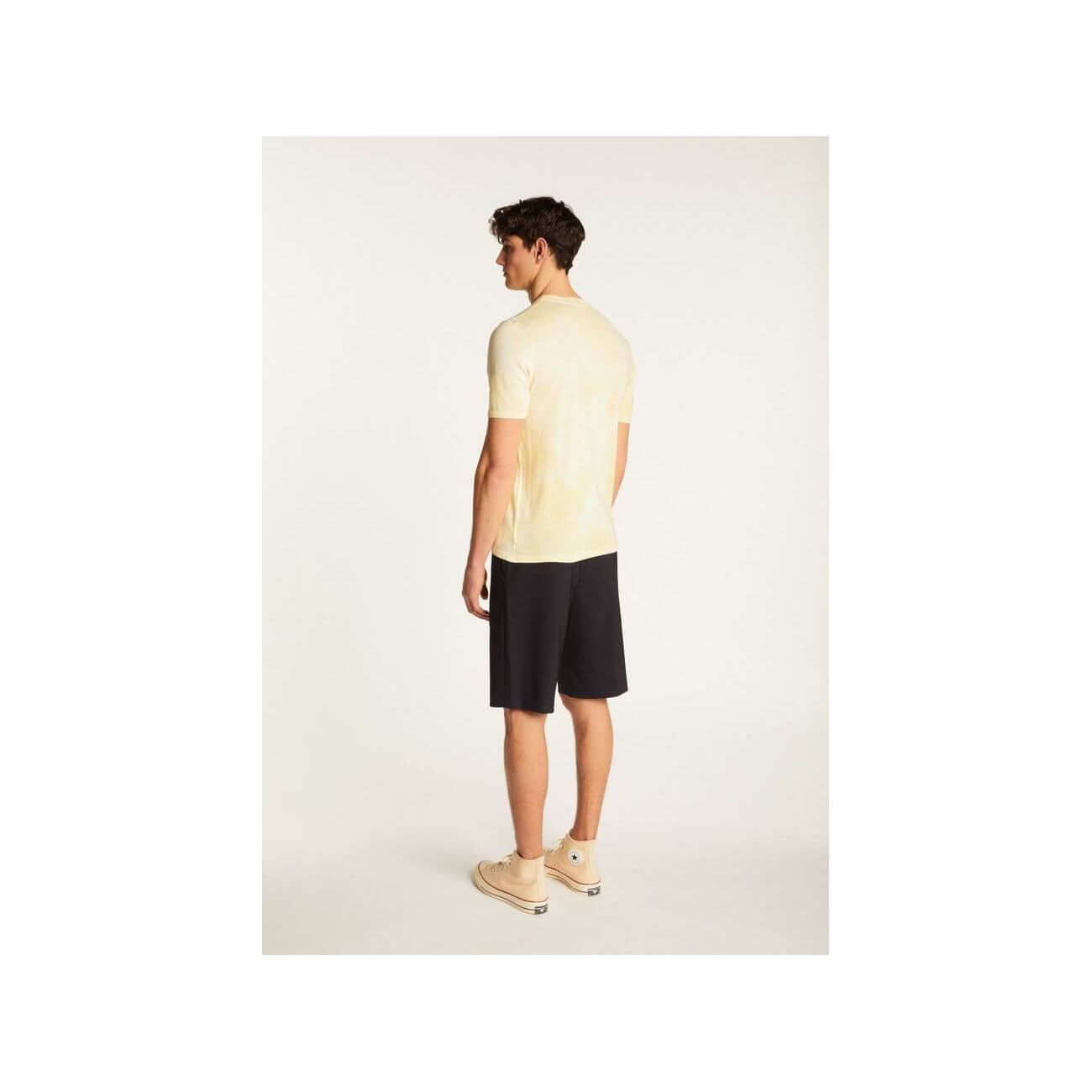 Back view of a model wearing the T-Shirt Marquez in light yellow with shorts, showcasing its modern style.