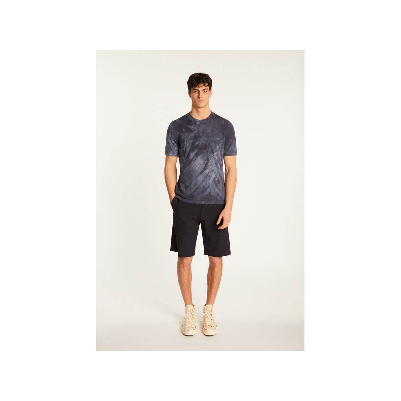 Model wearing T-Shirt Marquez in navy, paired with shorts for a casual summer look.
