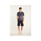 Model wearing T-Shirt Marquez in navy, paired with shorts for a casual summer look.