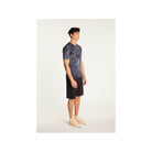 Model displaying the Marquez T-Shirt in a stylish tie-dye pattern, paired with shorts for a casual look.