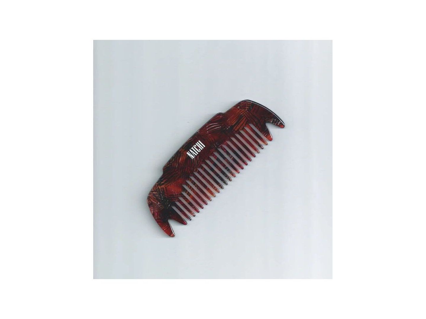 Peigne Coco en acétate de cellulose, conçu pour démêler et favoriser la santé des cheveux.