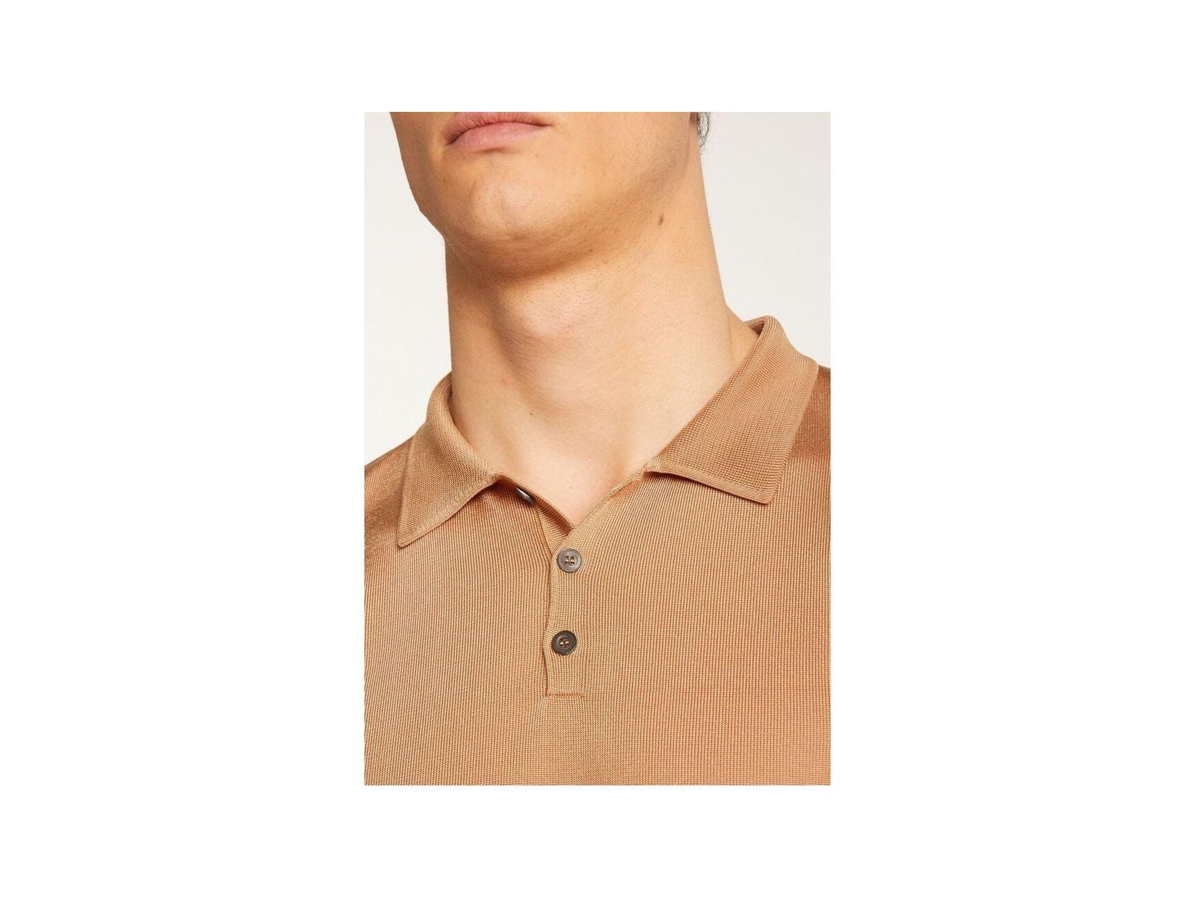 Close-up of a beige Polo fil lumière Babar shirt, showcasing its soft texture and button details.