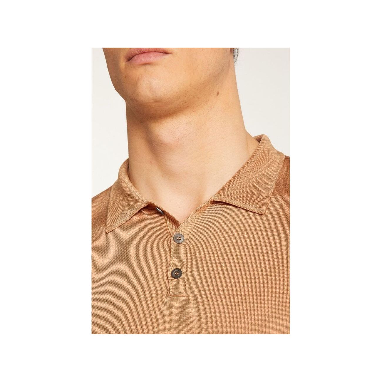 Close-up of a beige Polo fil lumière Babar shirt, showcasing its soft texture and button details.
