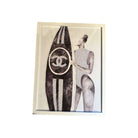 Art print of a stylish woman with a Chanel surfboard, showcasing a fashionable and chic beach aesthetic.