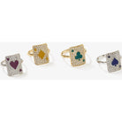 Set of four sparkling rings each featuring playing card designs with hearts, diamonds, clubs, and spades.